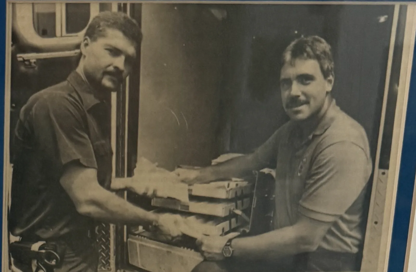 Grant Roberts and Vito Palumbo checking equipment in the back of an ambulance before the 1993 state competition